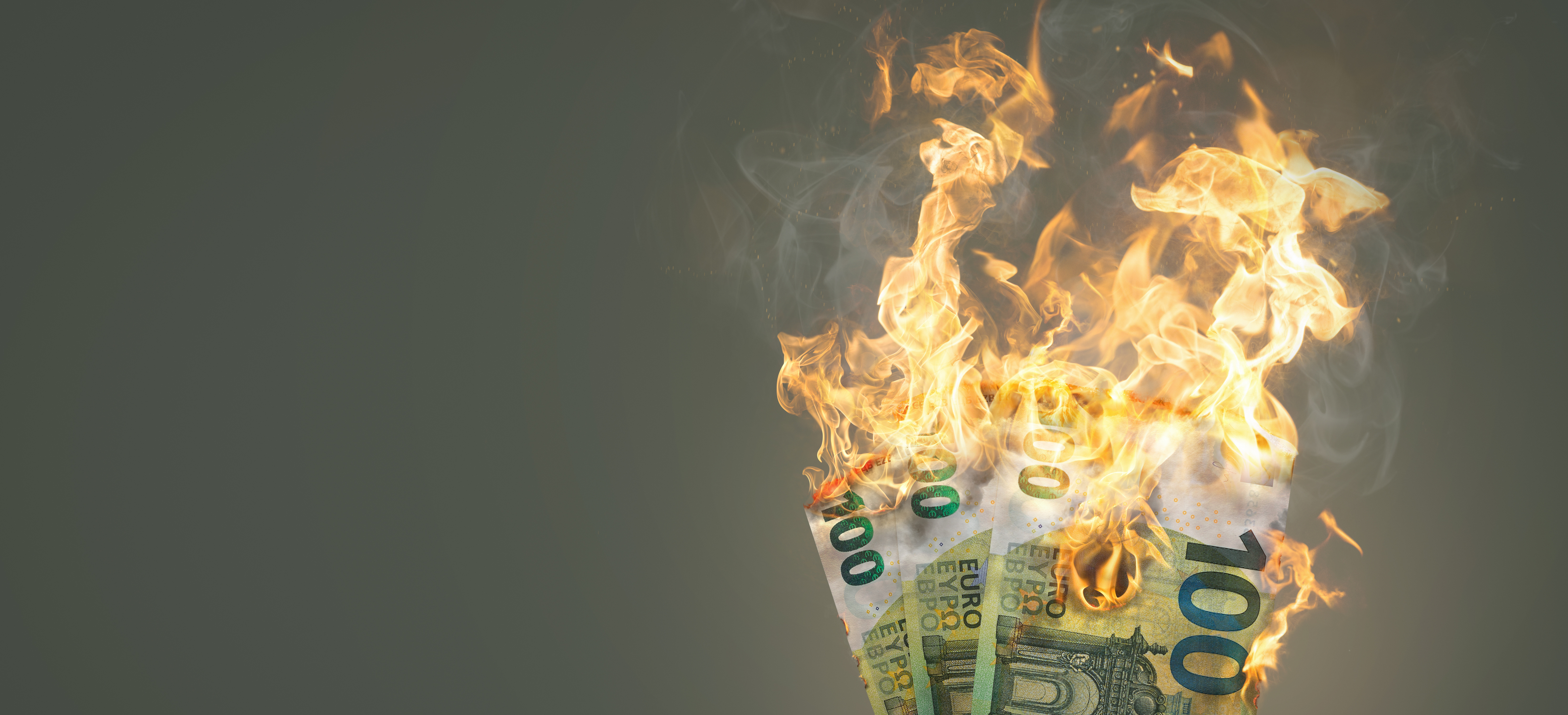 Burning money - 100 Euro banknotes on fire